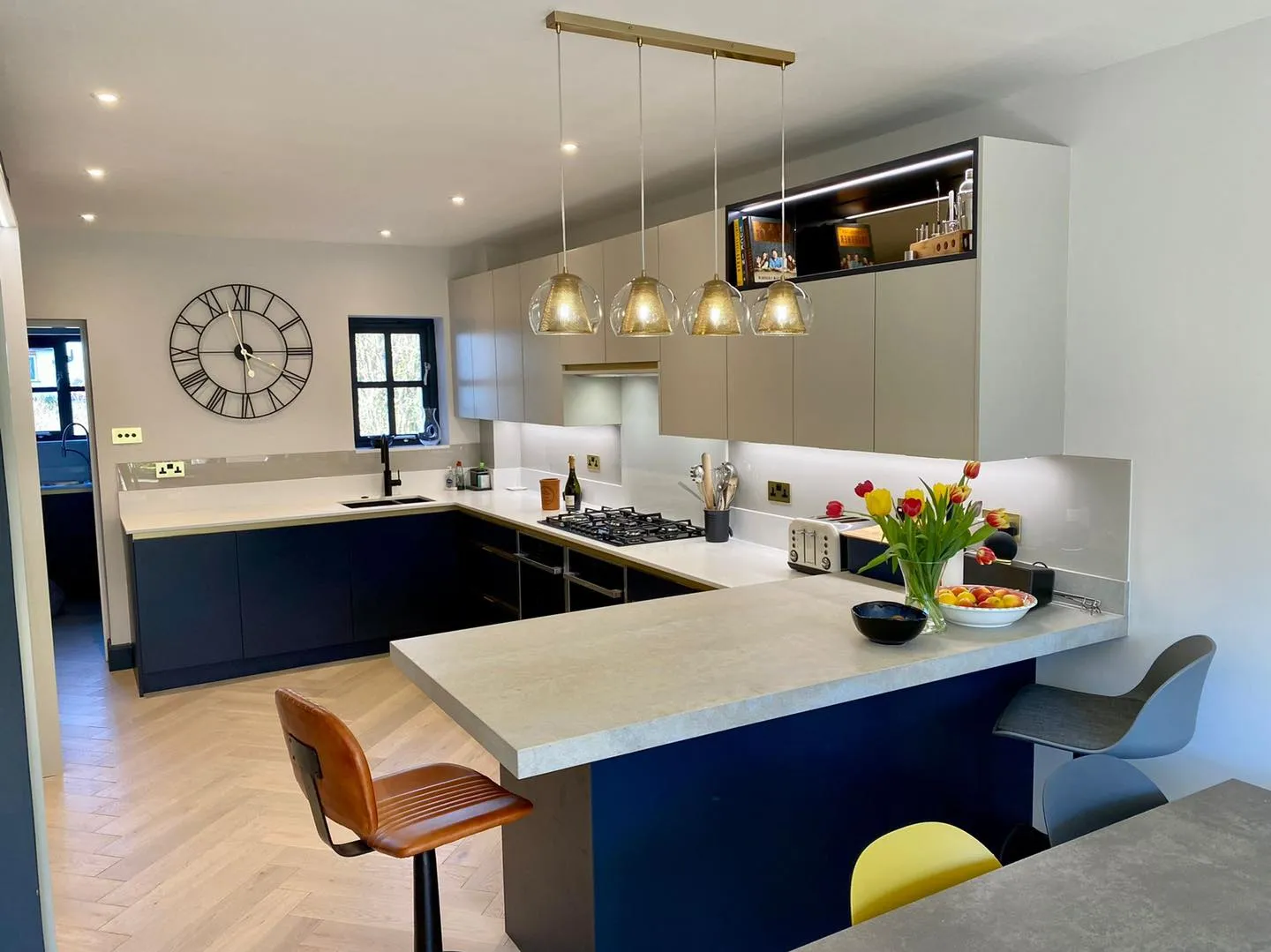 a kitchen with a center island and a clock on the wall