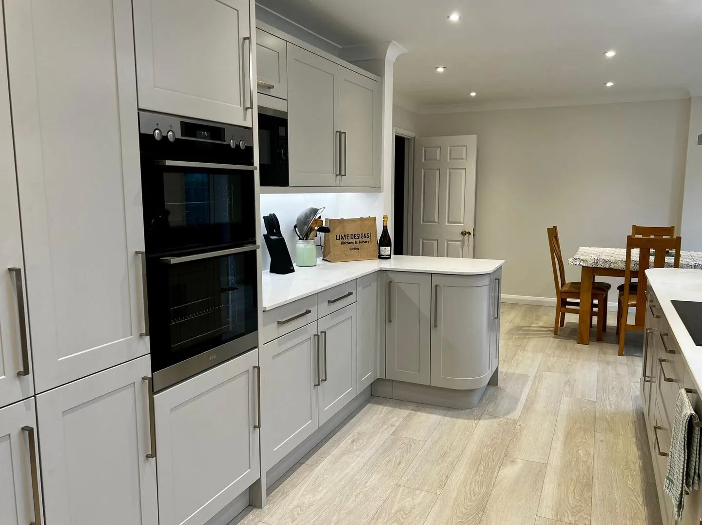 a kitchen with white cabinets and a black oven
