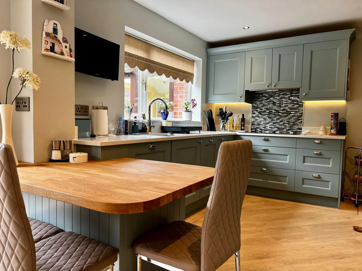 a kitchen with a wooden table surrounded by chairs