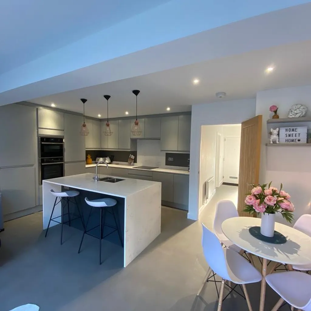 a kitchen with a table, chairs and a refrigerator